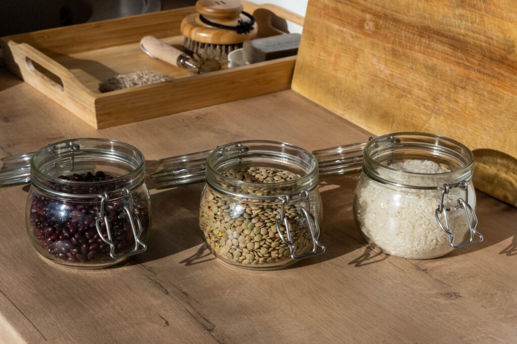 Glass jars of seeds on a wooden tabletop
