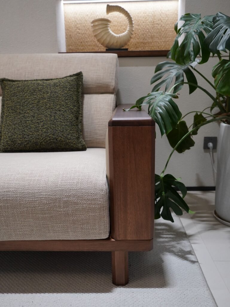 An olive green cushion cover on a sofa.