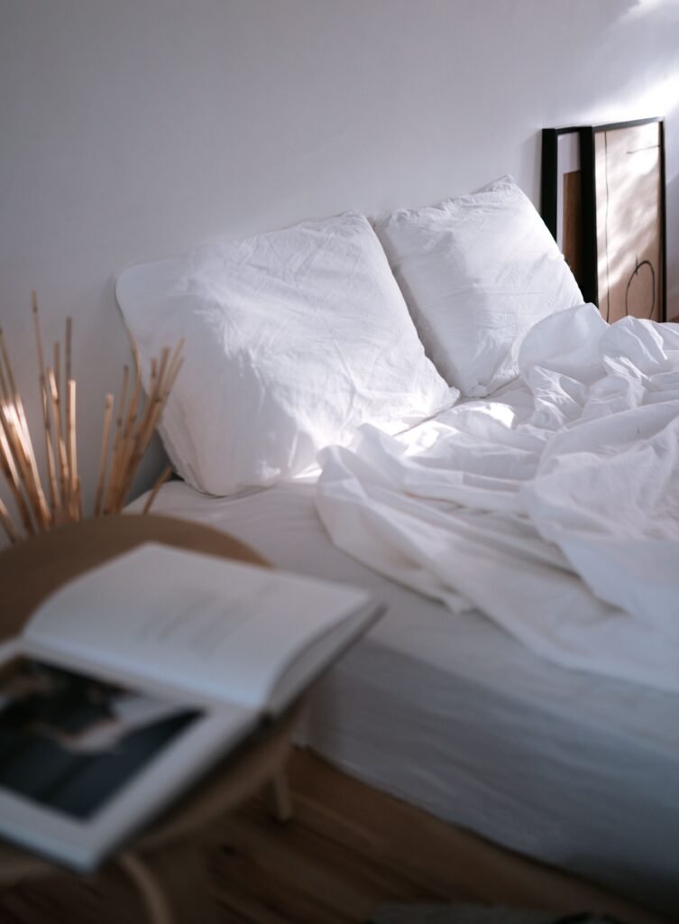 Bedding and natural wood bedroom furniture.