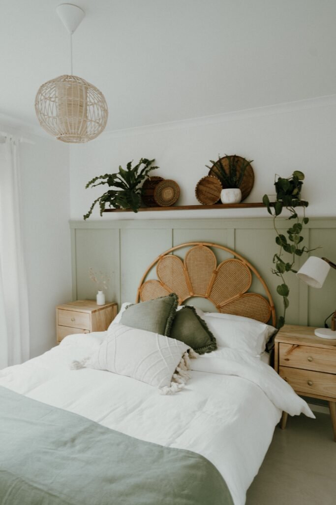 Sage green bedding in a bedroom with natural wood furniture.